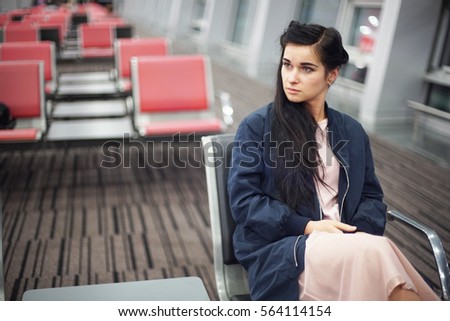 Beautiful girl. The brunette at the airport. Beautiful girl at the airport. A girl waiting for flight
