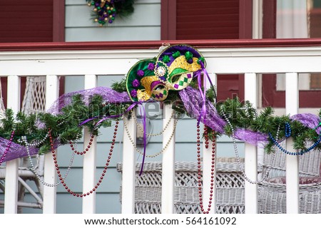 Mardi Gras decorations on white picket fence in Galveston, Texas