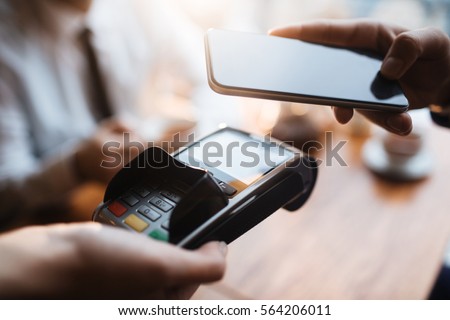 Paying with Mobile Phone Royalty-Free Stock Photo #564206011