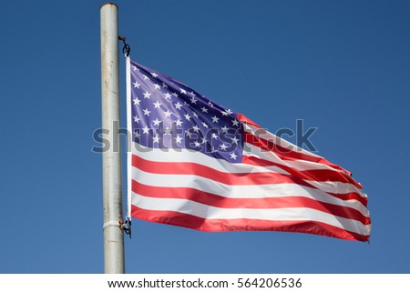 American flag under blue sky