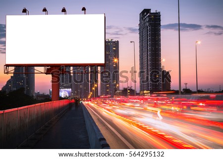 Blank billboard with light trails, street and urban in the twilight or night - can advertisement for display or montage product or business.