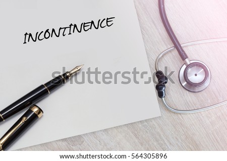 Incontinence word with stethoscope and pen on wooden background as medical concept
