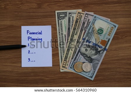 Financial Planning words written on paper note on wooden table with dollar cash, and pen, Finance saving investment concept