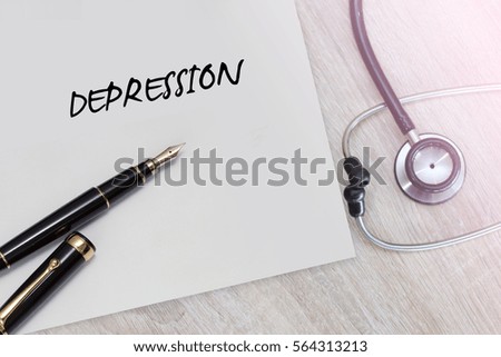 Depression word with stethoscope and pen on wooden background as medical concept