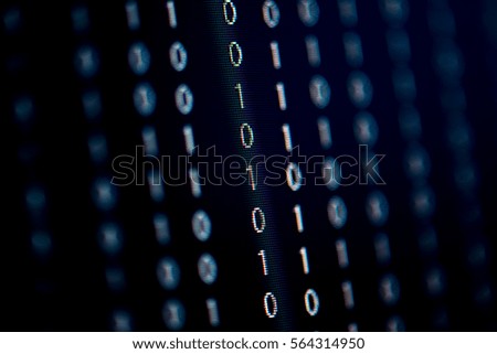 Digital binary data on computer screen, selective focus.