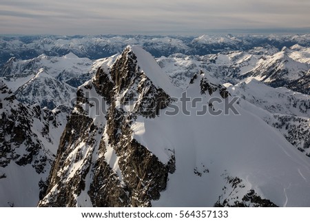 Beautiful aerial view on the mountain landscape of British Columbia, Canada. Picture taken of Mount Judge, during a cloudy winter evening.
