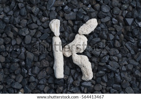 White Death Coral alphabet on coal black stone backgrounds
