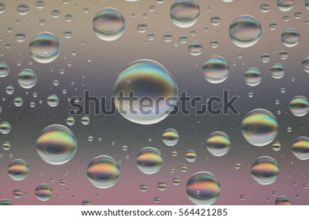 Rain on glass. Water drops isolated on colorful background.  Sun light, rays of sunshine. Simple website template. Soft blur color