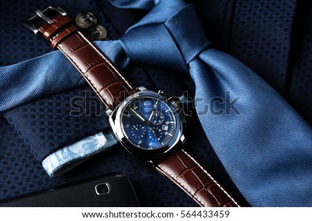 luxury fashion watch with blue dial and brown crocodile grain leather watch band Royalty-Free Stock Photo #564433459
