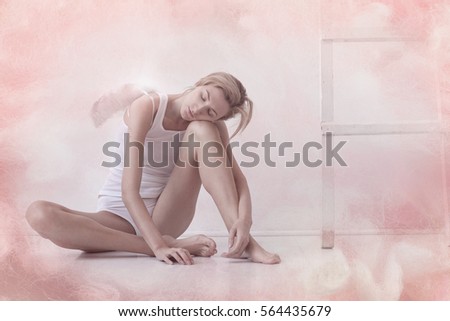 A sleeping angel. Beautiful girl with white wings sitting on the floor with my eyes closed