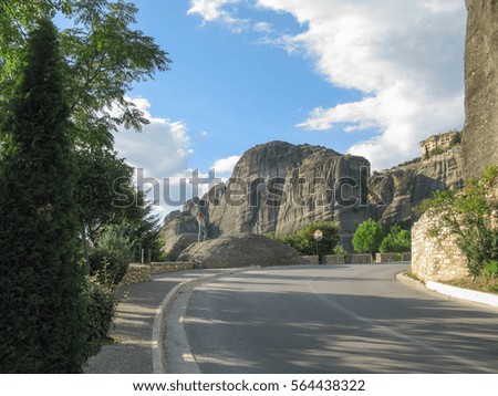 Man takes a picture of Meteora Monastery on rocks. Thessaly, Greece.
