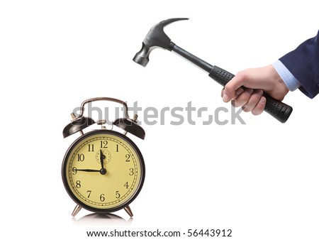 A businessman's hand about to break an old clock isolated on a white background