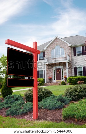 A nice luxury home with a blank for sale sign posted in front.  Plenty of copy space on the empty sign for your text.