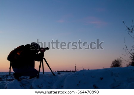 silhouette of photographer on the top of the mountain at sunrise and sunset
