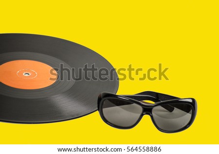 vintage vinyl record and eyewear on a colored background yellow