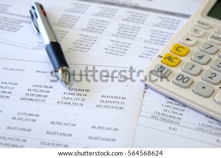 Reports of business financial statement with pen and calculator