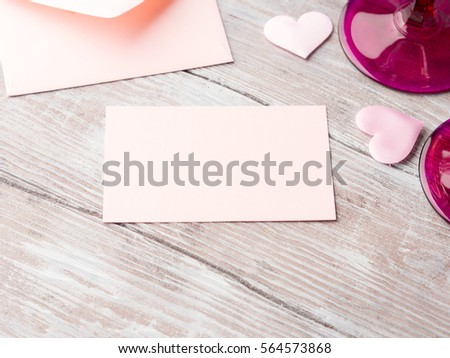 Blank pink paper letter note with hearts to fill with your text on wooden textured background. Valentine's day wedding romantic date invitation