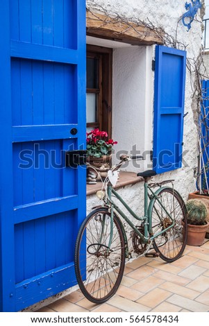 Vintage old  bicycle in front of cute flowered house in Spain