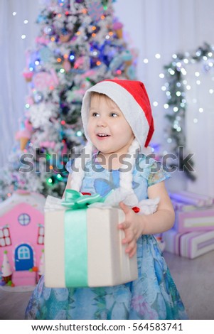 Child girl in a Christmas interior. A Christmas card.