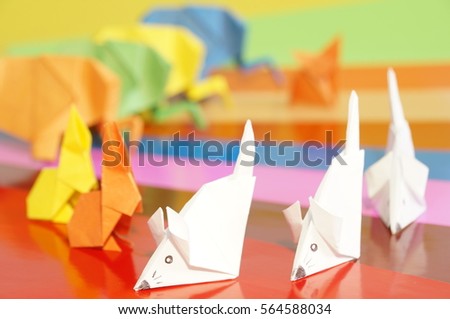Paper origami animals isolated on a colorful background