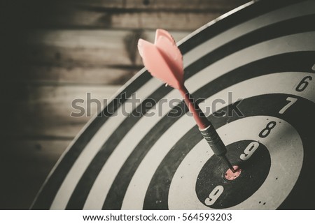 Bullseye is a target of business. Dart is an opportunity and Dartboard is the target and goal. So both of that represent a challenge in business marketing as concept. Royalty-Free Stock Photo #564593203