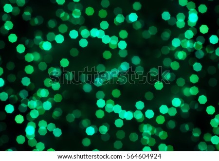 Green bokeh polygon on a dark background, abstract pattern