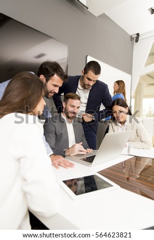 Young successful managers discussing new business project in modern office