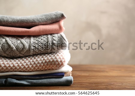 Pile of clothes on table Royalty-Free Stock Photo #564625645