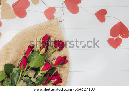 Flower with shadow of wooden battens on white wooden table background on Valentine's Day times with copy space.