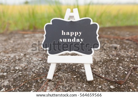happy friday signboard over paddy field background