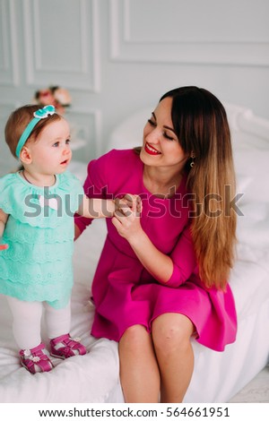 Mother and baby closeup portrait, happy faces, european family picture, adorable small girl, mom and kid having fun indoor, parents joy, holding little child, healthy 