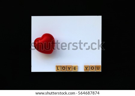 Red Heart and LOVE YOU text word made with wood blocks on white board blackboard.Valentine Concept