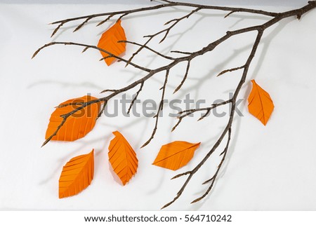 Autumn paper origami leaf on white background