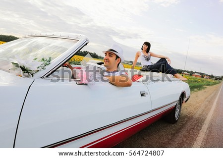a man driving a happy woman in the background, warm and happy picture
