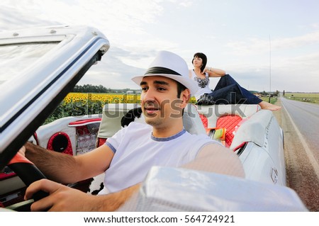 a man driving a happy woman in the background, warm and happy picture