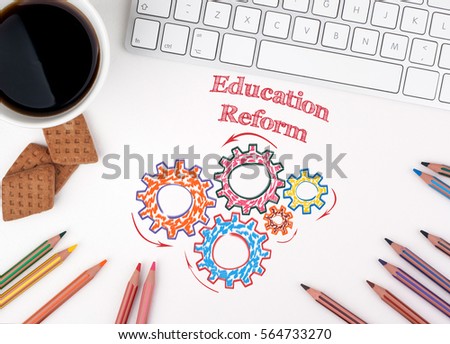 Education Reform. Computer keyboard and a coffee mug on a white table