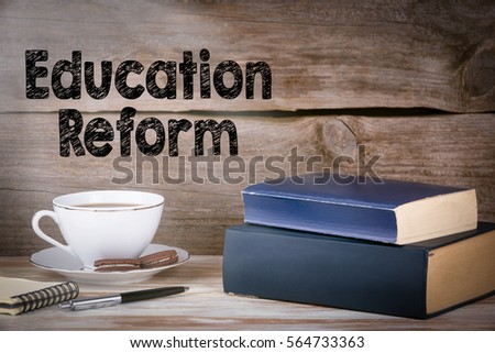 Education Reform. Stack of books on wooden desk