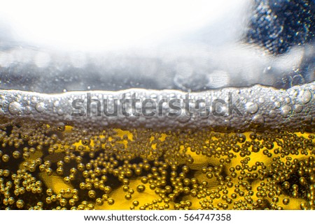 Beer lighting bubbles and sparkles in black background macro picture