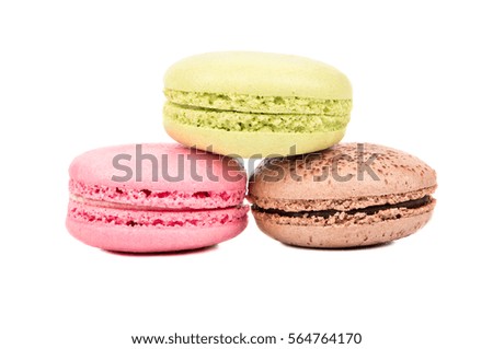 Chocolate, pistachio and pink macaroon on a white background