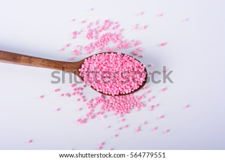 Red sago pearls on a wooden spoon. Selective Focus.