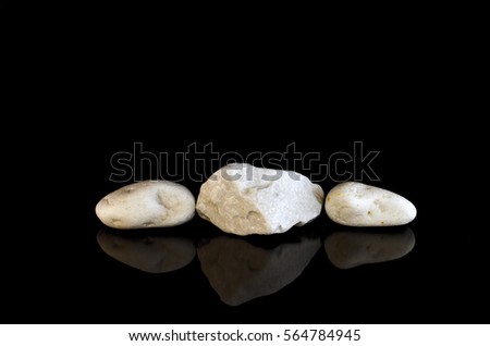White stones on black background