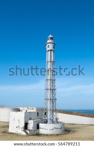 Trafalgar's lighthouse at the province of Cadiz with clear blue sky in the background.