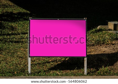 pink blank sign against  the lawn 