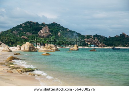Beautiful landscape with view of ocean, perfect beach, big stones, trees, azure water. Background image. Concept  travel