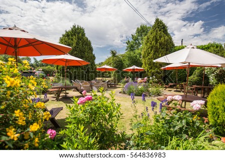Typical pub garden in England on a summers day Royalty-Free Stock Photo #564836983