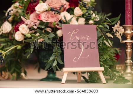 table number and flower composition Royalty-Free Stock Photo #564838600