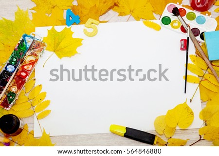 Watercolor paint, brush for painting and autumn leaves