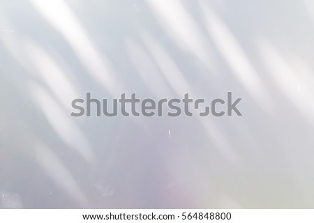 light and shadow bokeh on white wall. Royalty-Free Stock Photo #564848800