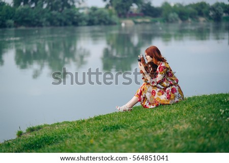 Woman in the park takes pictures