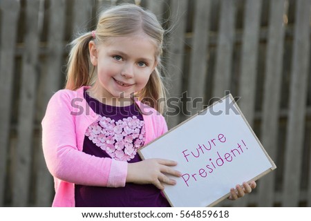 Young girl child holding sign saying Future President for Women's Rights